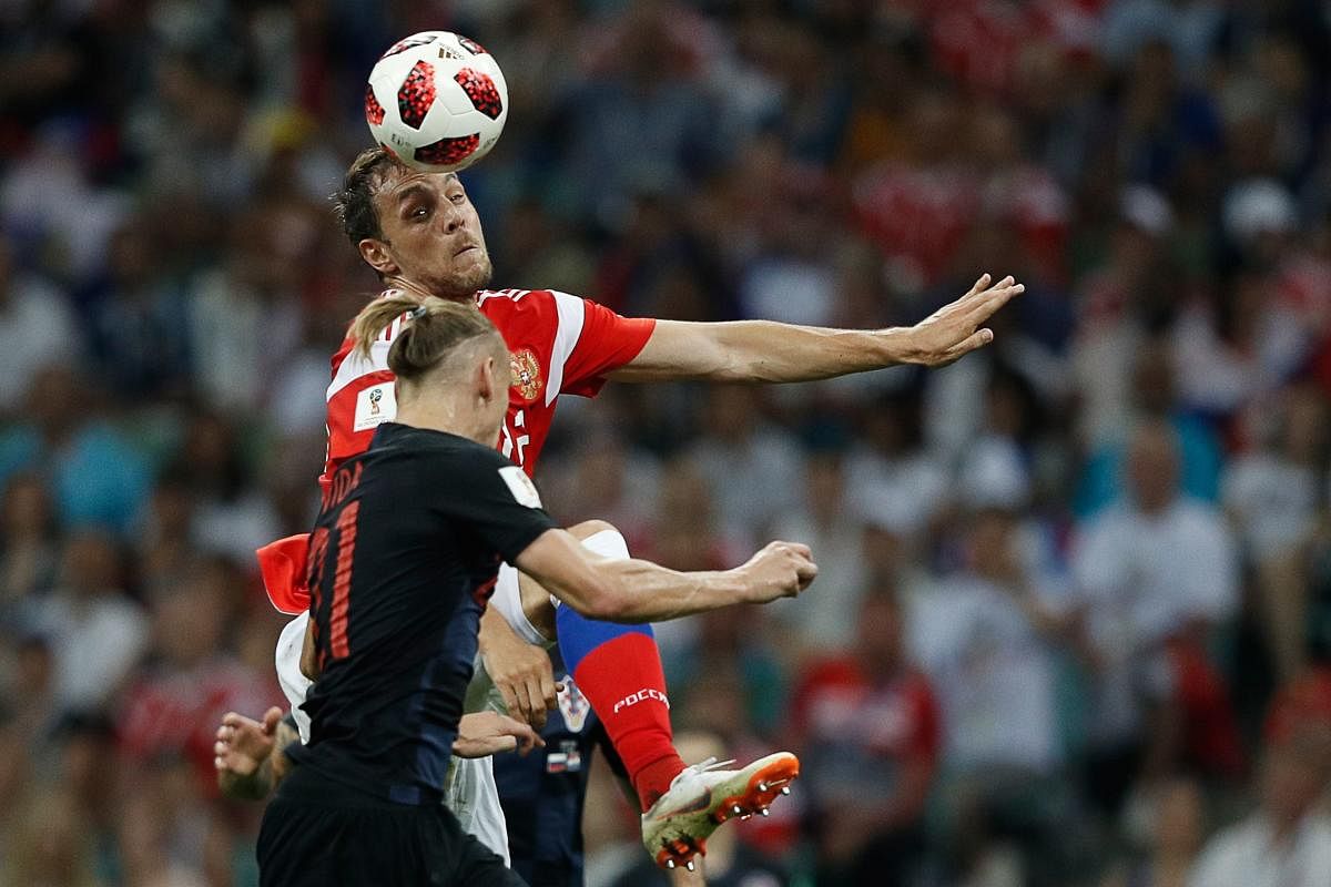 Russia's forward Artem Dzyuba (back) vies for the header with Croatia's defender Domagoj Vida during the Russia 2018 World Cup quarter-final football match between Russia and Croatia at the Fisht Stadium in Sochi on July 7, 2018. AFP PHOTO