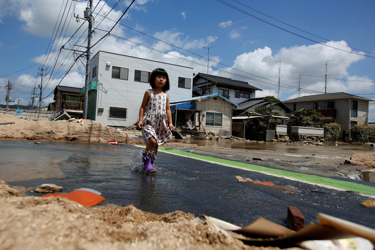 A local resident walks in a flood affected area in Mabi town in Kurashiki, Okayama Prefecture, Japan, July 10, 2018. (REUTERS/Issei Kato)