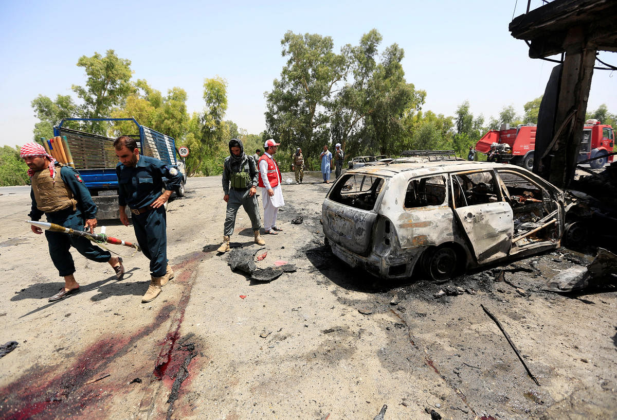 Afghan policemen inspect the site of a suicide attack in Jalalabad city, Afghanistan July 10, 2018. (REUTERS/Parwiz)