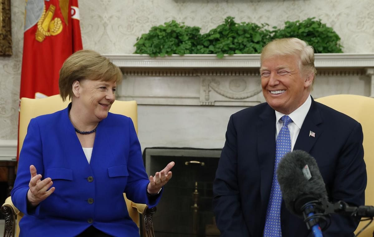 US President Donald Trump and  German Chancellor Angela Merkel in the White House Oval Office in Washington. Reuters File Photo