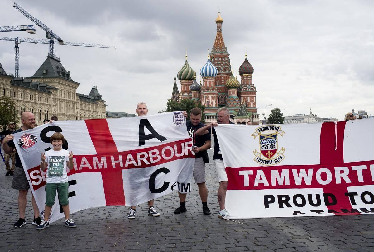  England soccer fans pose for a photo with their club banners in Red Square during the 2018 soccer World Cup in Moscow, Russia, Tuesday, July 10, 2018. (AP/PTI)