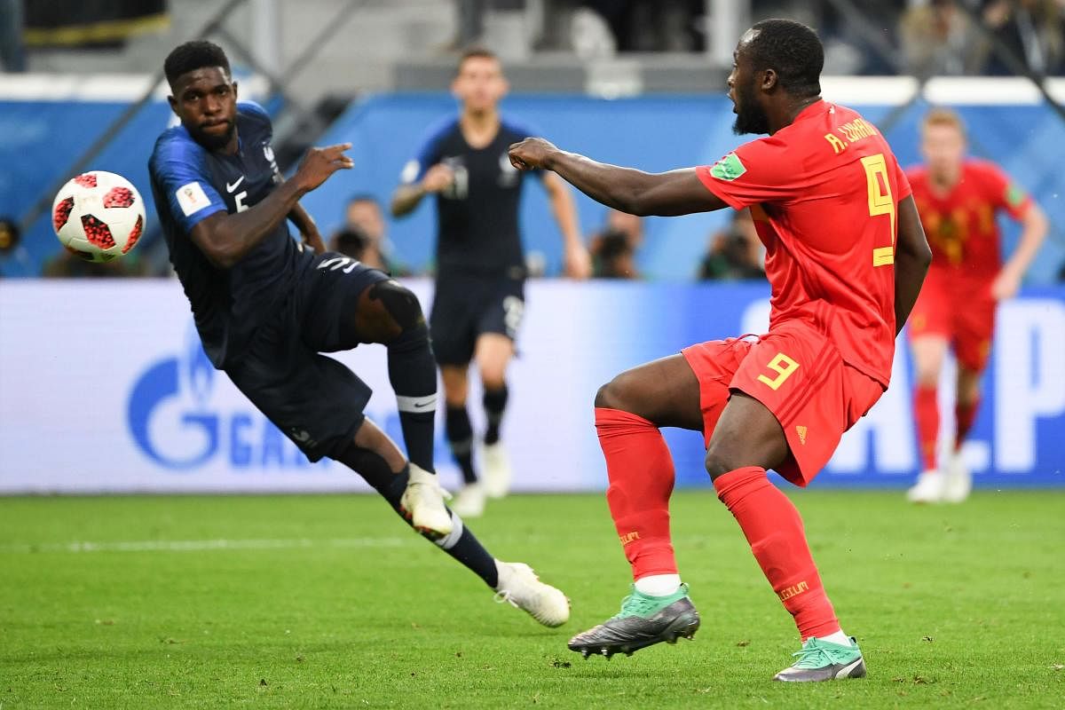 France's defender Samuel Umtiti (L) and Belgium's forward Romelu Lukaku vie for the ball during the Russia 2018 World Cup semi-final football match between France and Belgium at the Saint Petersburg Stadium in Saint Petersburg on July 10, 2018. / AFP PHOT