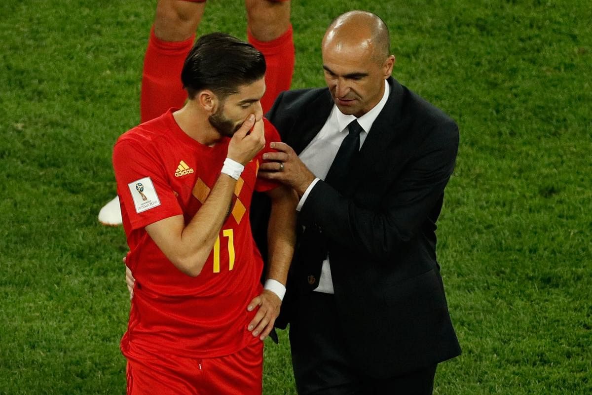 SAD SCENES: Belgium's midfielder Yannick Ferreira-Carrasco (left) is consoled by coach Roberto Martinez after they lost to France in the World Cup semifinal on Tuesday. (AFP Photo)