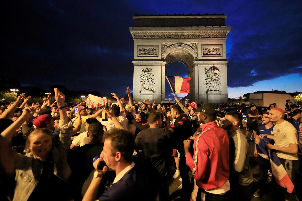 France fans react on the Champs-Elysees after defeating Belgium in their World Cup semi-final match. (REUTERS/Gonzalo Fuentes)