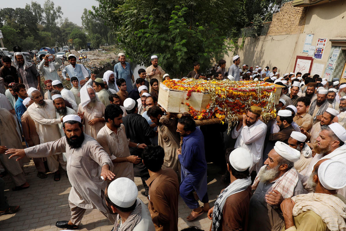 Men and relatives carry a coffin of a victim, who was killed with others in TuesdayÕs suicide attack during an election campaign meeting in Peshawar, Pakistan July 11, 2018. (REUTERS/Fayaz Aziz)