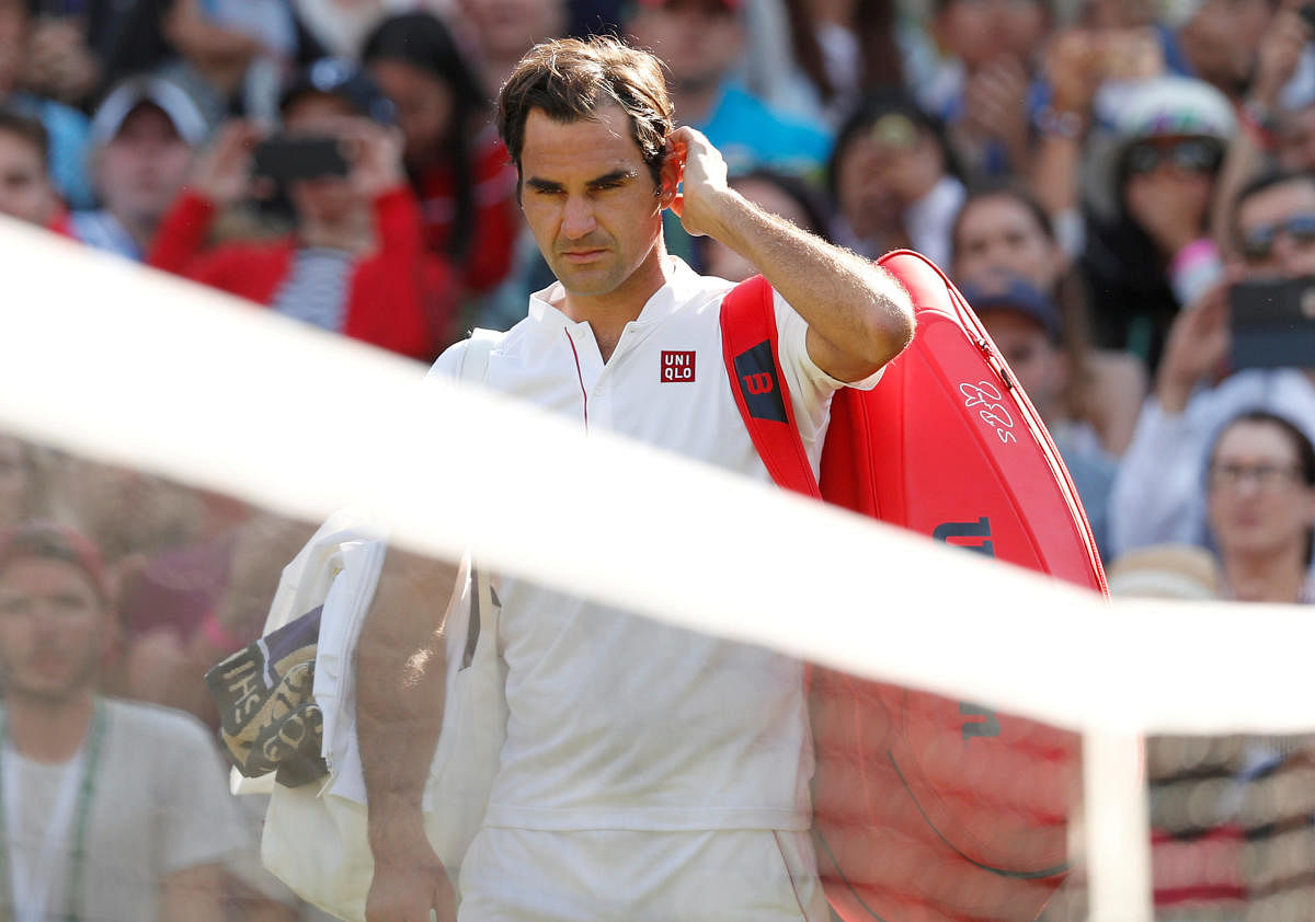 Roger Federer walks off court after loosing his quarter final match against South Africa's Kevin Anderson. Reuters