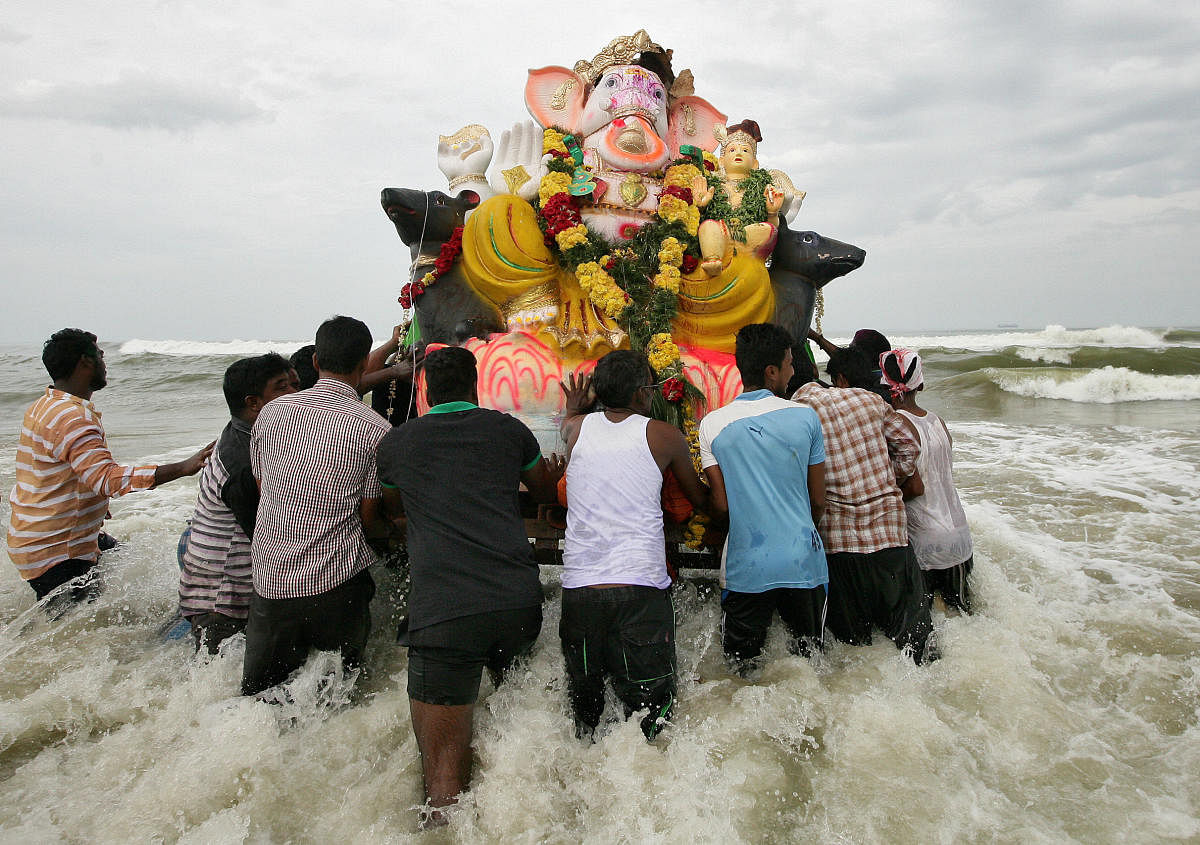 Devotees carry an idol of the Ganesh, the deity of prosperity, into the Bay of Bengal for its immersion during the ten-day-long Ganesh Chaturthi festival. (Reuters File Photo)