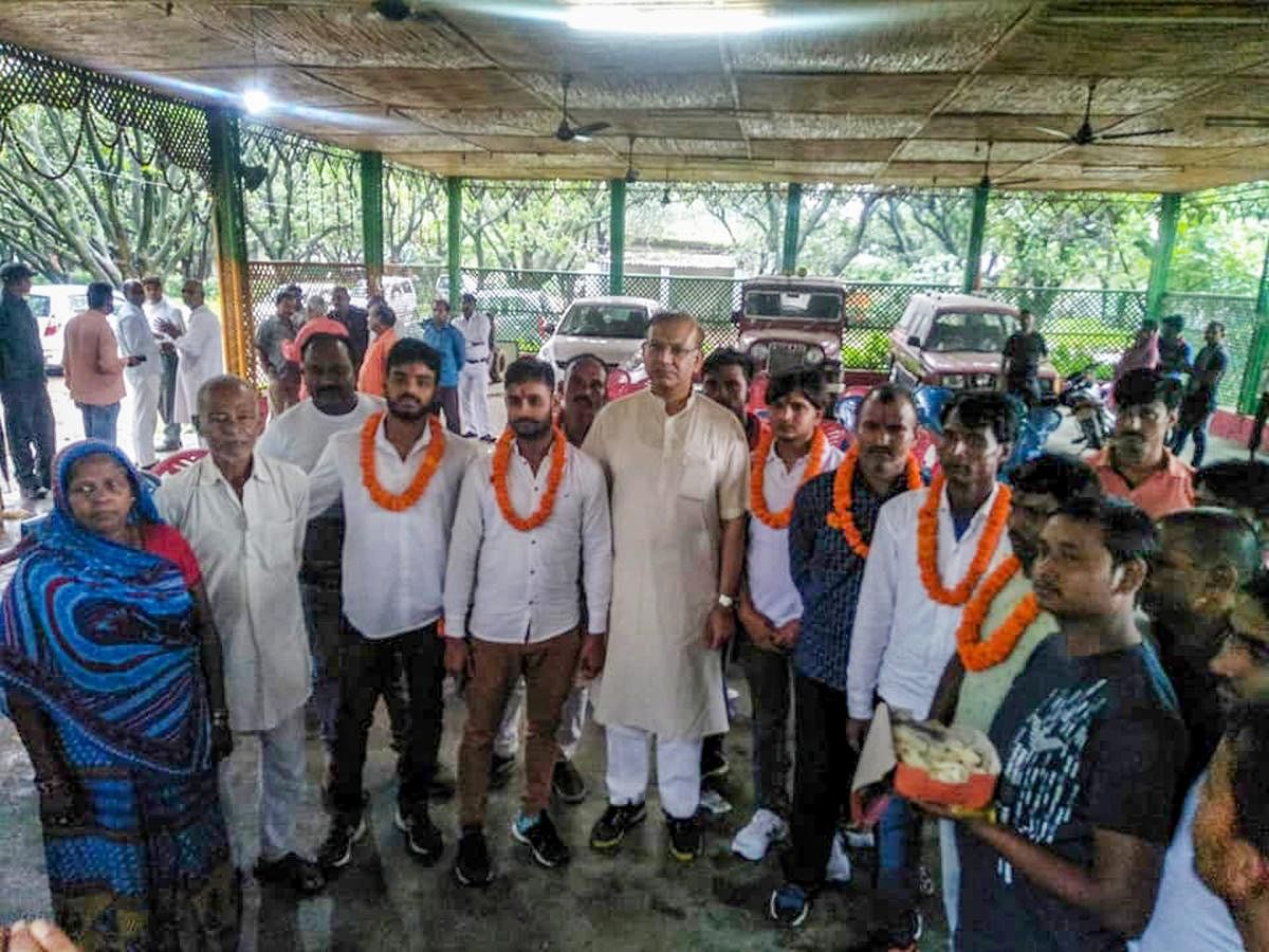 Union Minister of State for Civil Aviation Jayant Sinha with the lynching convicts at his residence after they were released on bail in Ramgarh, Jharkhand on Saturday, July 7, 2018. (PTI Photo).