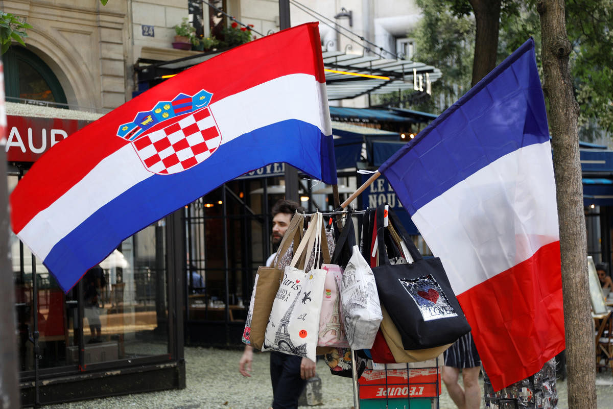 A Croatian flag and a French flag on sale flies on a kiosk in Paris, prior to the upcoming World Cup final between France and Croatia, France, July 13, 2018. REUTERS.