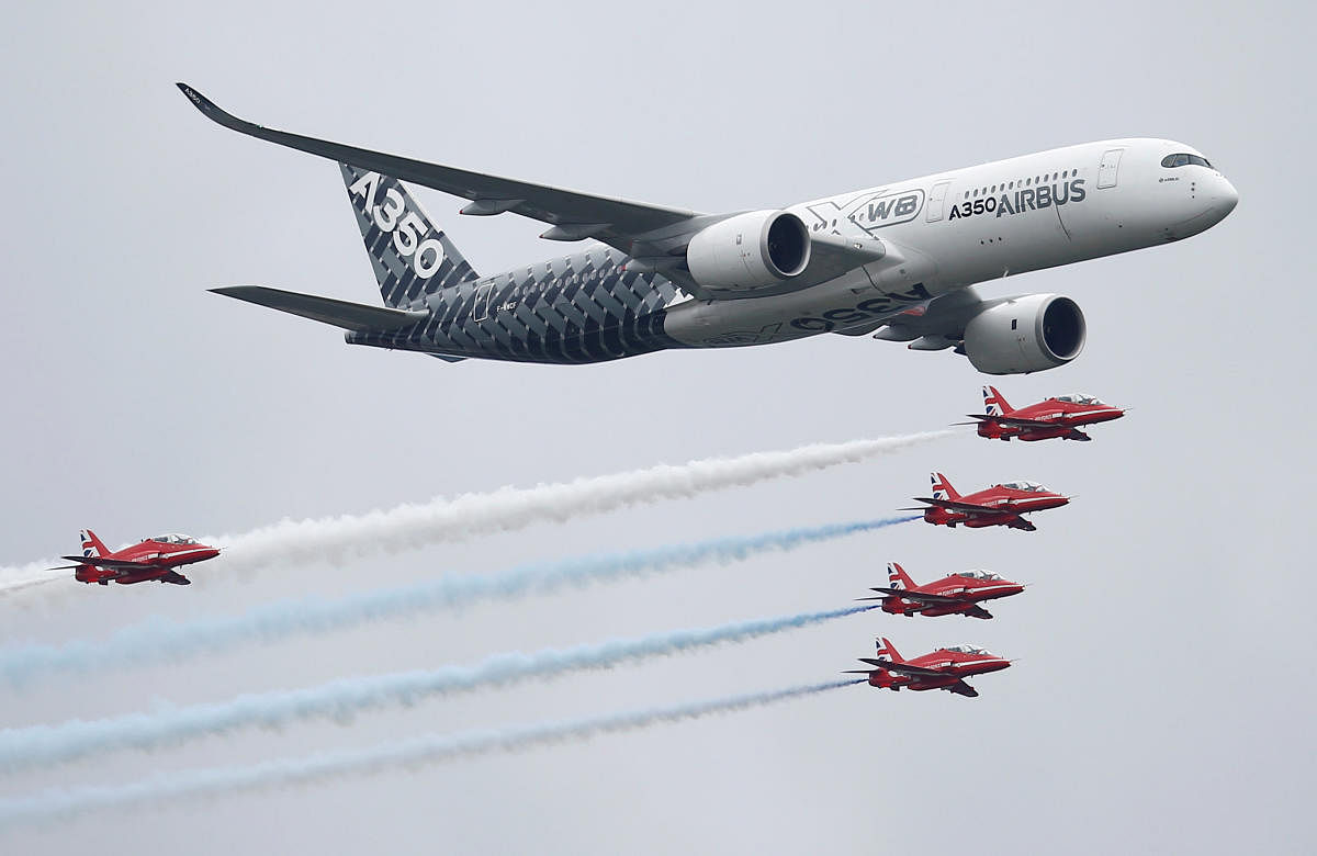 An Airbus A350 aircraft flies in formation with Britain's Red Arrows flying display team at the Farnborough International Airshow in Farnborough, Britain. (Reuters Photo)