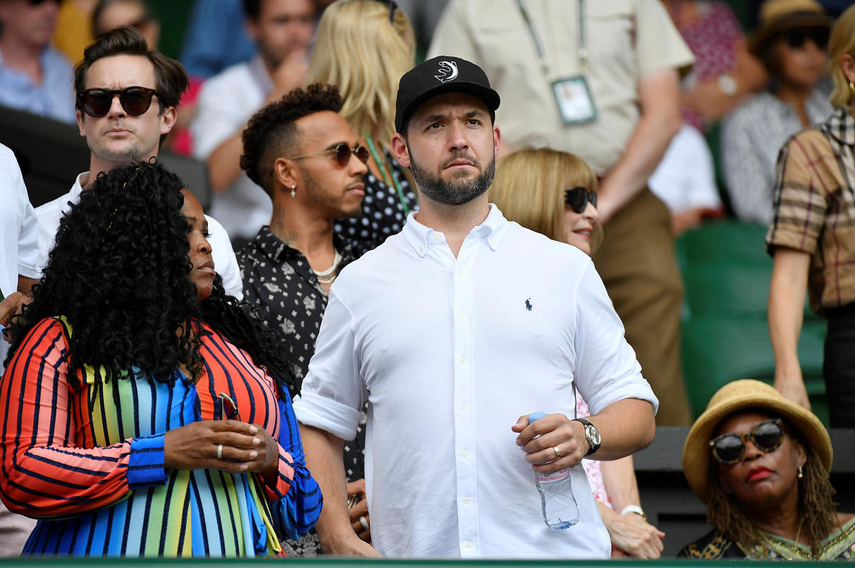 Alexis Ohanian and Lewis Hamilton arrive for Serena Williams of the U.S.' final against Germany's Angelique Kerber. Reuters