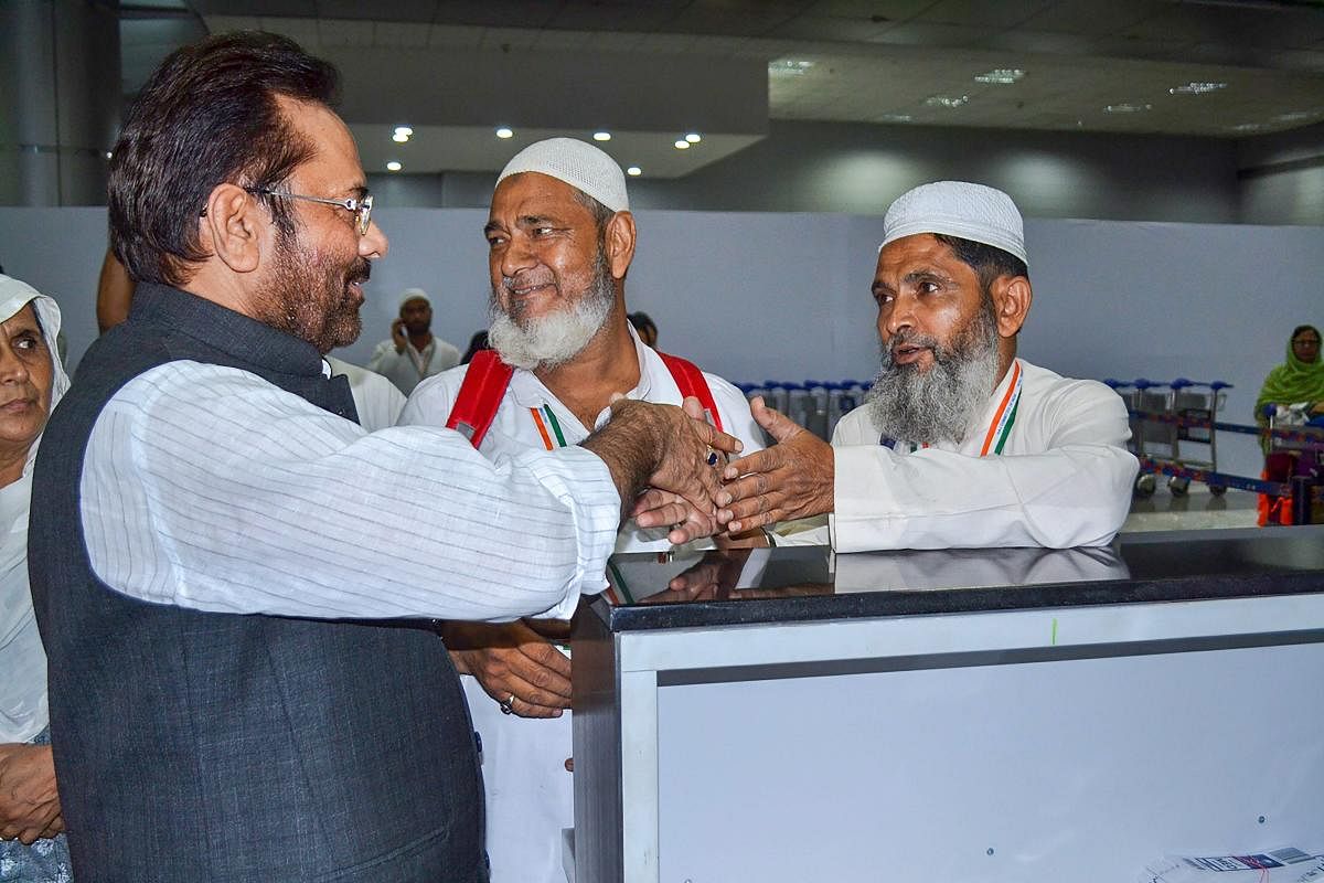 Union Minister for Minority Affairs Mukhtar Abbas Naqvi greets the first batch of Haj pilgrims before leaving for Saudi Arabia from Haj Terminal at Indira Gandhi International Airport, in New Delhi on Saturday, July 14, 2018. (PTI Photo)