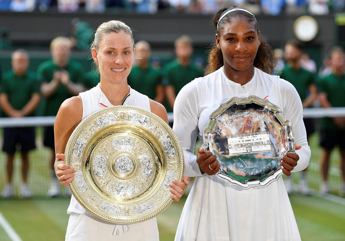 Germany's Angelique Kerber and Serena Williams of the U.S. hold their trophies after Kerber won the women's singles final. Reuters photo