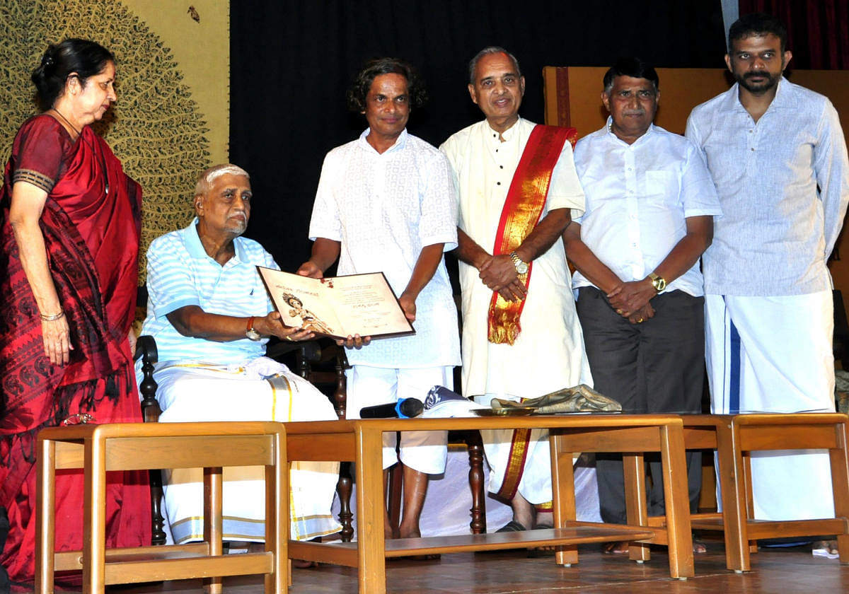 Veteran scholar Bannanje Govindacharya (2nd from left) honours senior Yakshagana artiste Bannanje Sanjeev Suvarna with the Yakshagana Kalaranga award at the Udupi Purabhavana on Sunday.
