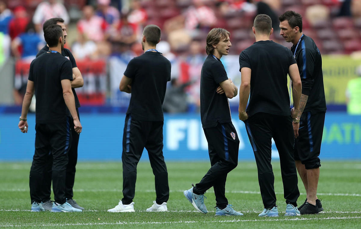 Croatia's Luka Modric (C), Mario Mandzukic (R) and team mates on the pitch before the match. Reuters
