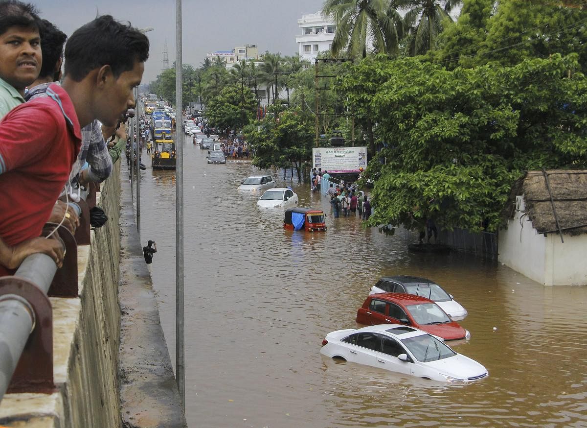 Vehicles ply at a flooded road after heavy downpour, in Bhubaneswar on Sunday, July 1, 2018. PTI file photo.