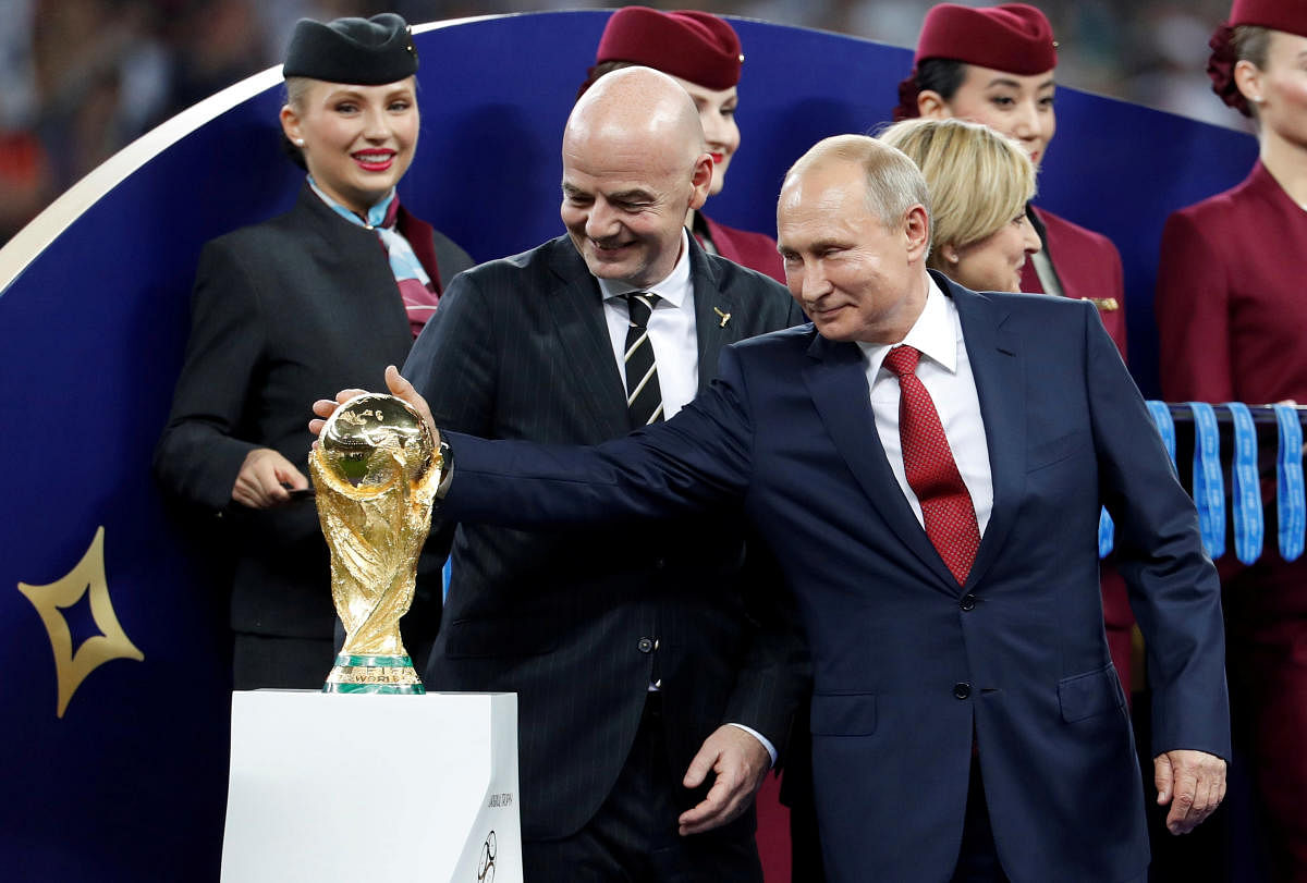 FIFA president Gianni Infantino and President of Russia Vladimir Putin with the World Cup trophy before the medals ceremony. Reuters