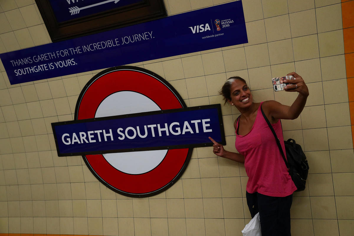 A passenger takes a selfie at Southgate Underground Station, temporarily renamed as 'Gareth Southgate' in honour of England soccer team manager Gareth Southgate, in London on Monday. (Reuters)