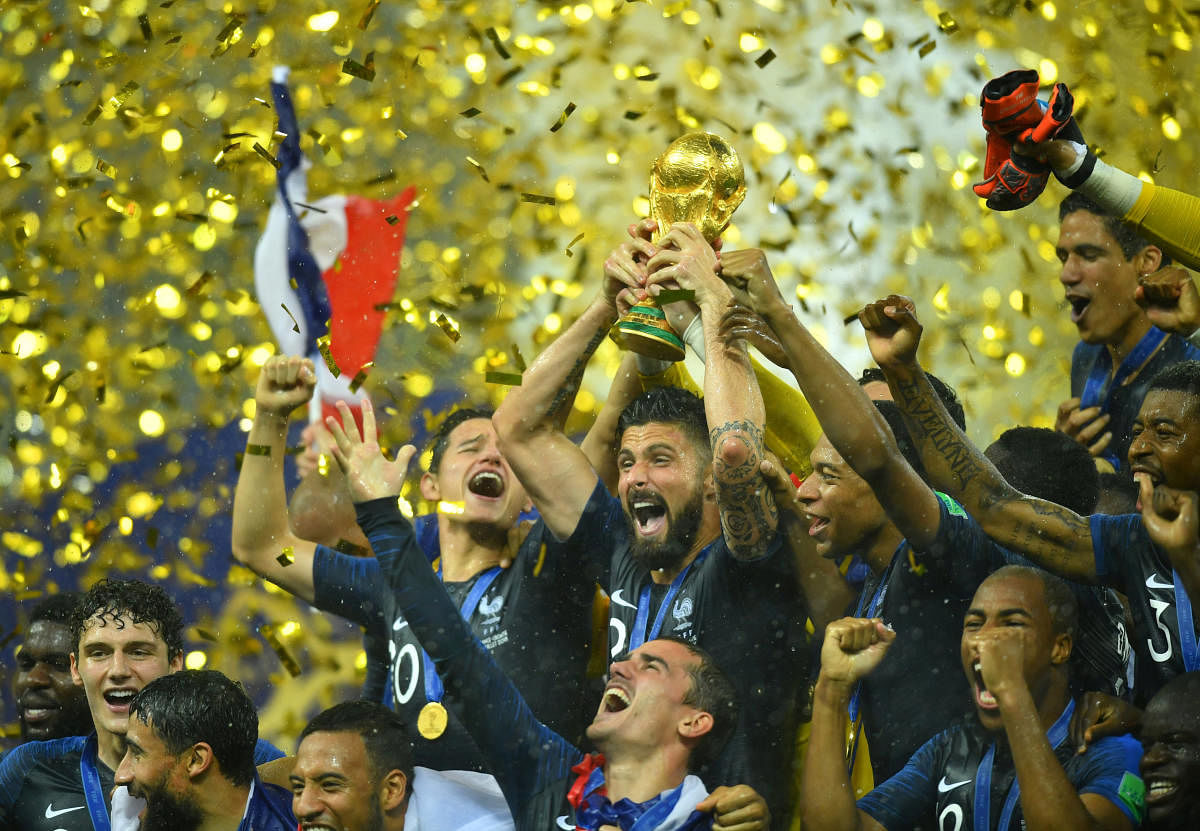 France's Olivier Giroud lifts the trophy as they celebrate winning the World Cup. (Reuters)