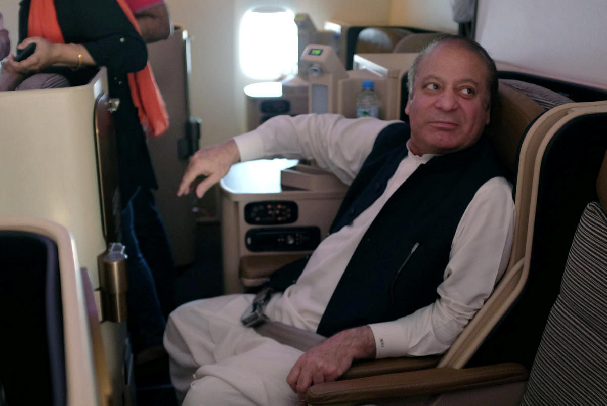 Ousted Pakistani Prime Minister Nawaz Sharif sits on a plane after landing at the Allama Iqbal International Airport in Lahore. Reuters photo