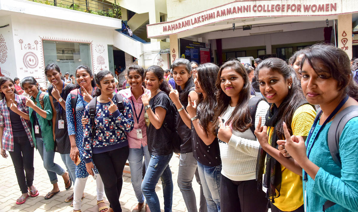 Students of the Maharani Lakshmi Ammanni College for Women show their inked fingers after the elections for the students’ association on Monday.  DH Photo/B H Shivakumkar
