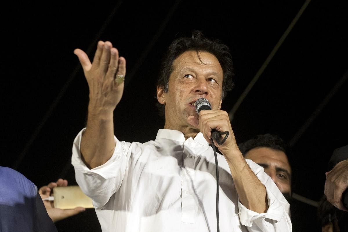 Pakistan's opposition politician Imran Khan, chief of Pakistan Tehreek-e-Insaf party, addresses his supporters during an election campaign in Karachi, Pakistan. AP/PTI file photo