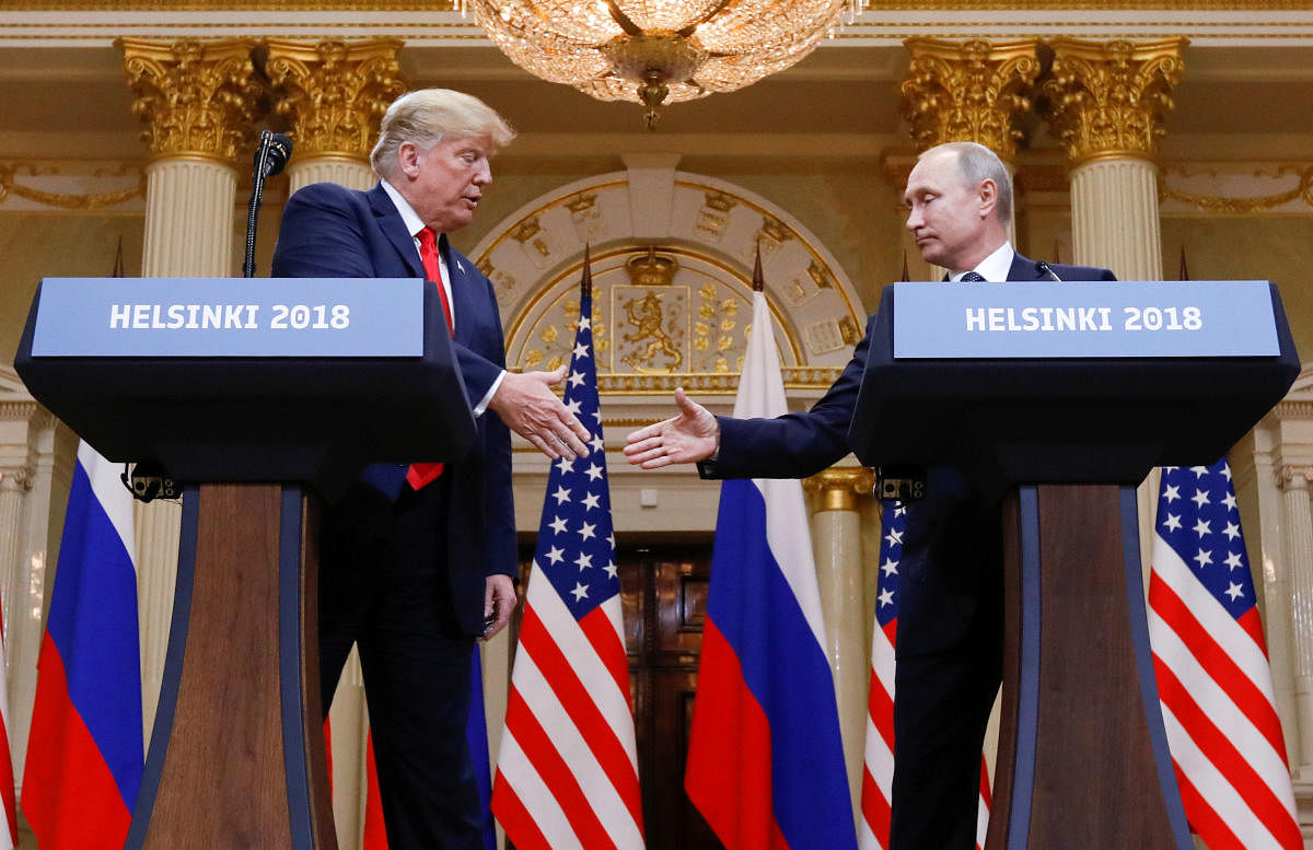 U.S. President Donald Trump and Russia's President Vladimir Putin shake hands during a joint news conference after their meeting in Helsinki, Finland, July 16, 2018. REUTERS.