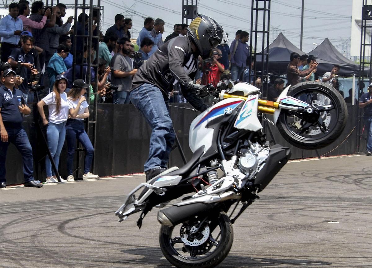 A stuntsman performs with a G310 bike during its launch, in Gurugram on Wednesday. PTI