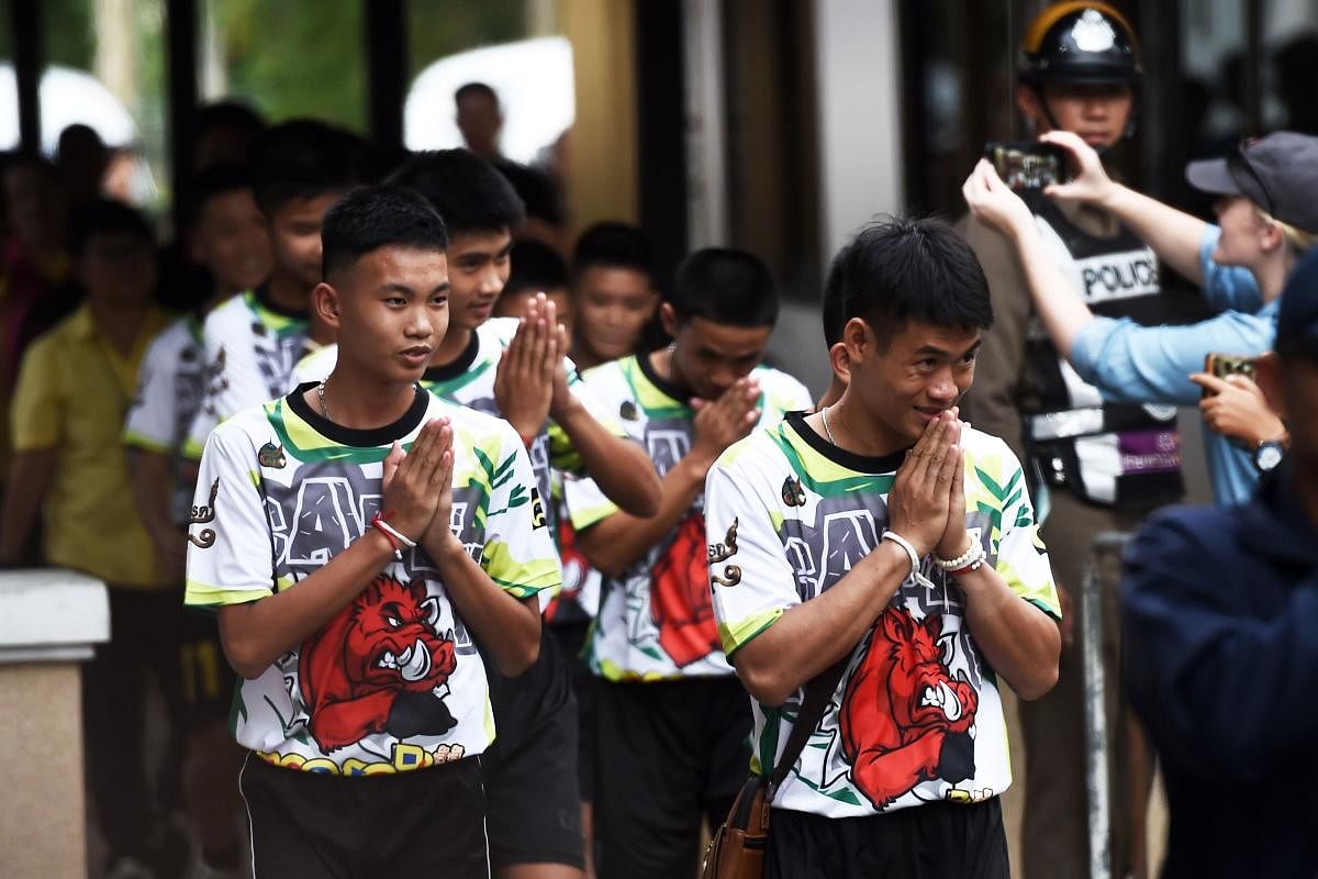 Some of the twelve Thai boys, rescued from a flooded cave after being trapped, arrive to attend a press conference in Chiang Rai. AFP file photo