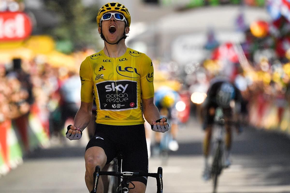 Jubilant: Great Britain's Geraint Thomas celebrates as he crosses the finish line to win the twelfth stage of the Tour de France. AFP