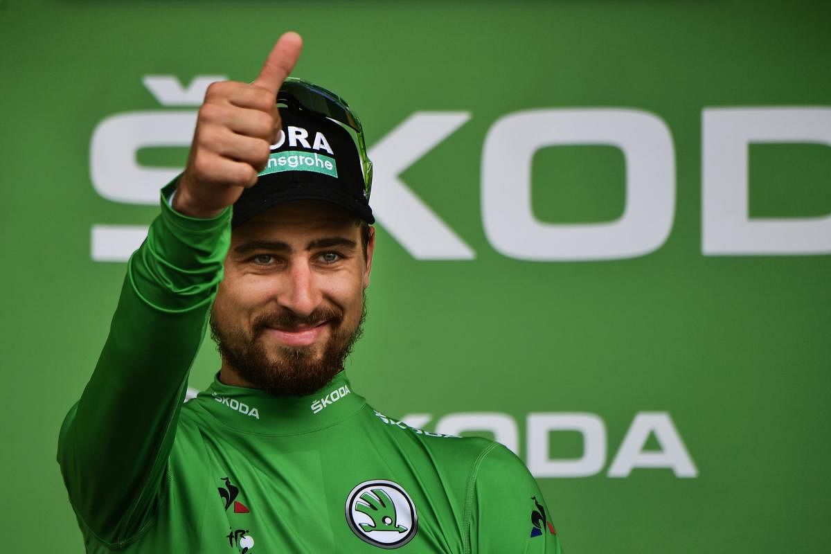 DOMINANT Slovakia's Peter Sagan, wearing the best sprinter's green jersey, celebrates on the podium after winning the 13th stage of the Tour de France on Friday. AFP