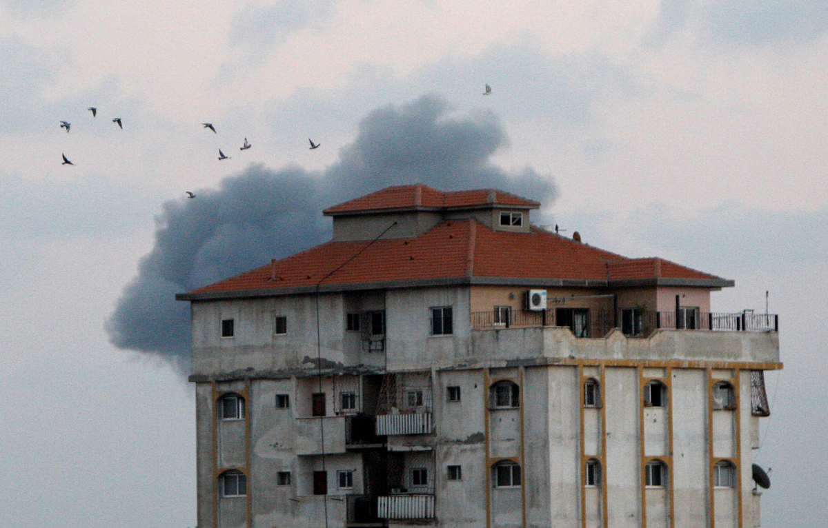 Smoke rises as birds fly following an Israeli air strike in Gaza City. Reuters