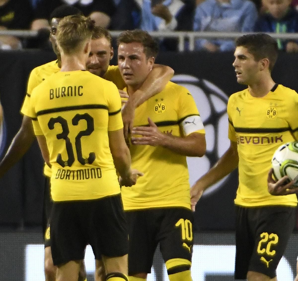 Borussia Dortmund's Mario Gotze (second from right) celebrates with team-mates after scoring against Manchester City on Friday. AFP