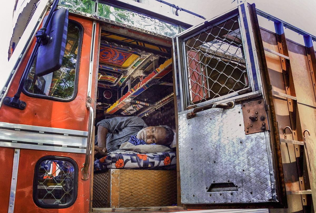 A driver rests in his truck during a strike called by transporters, in Amritsar on Saturday. PTI