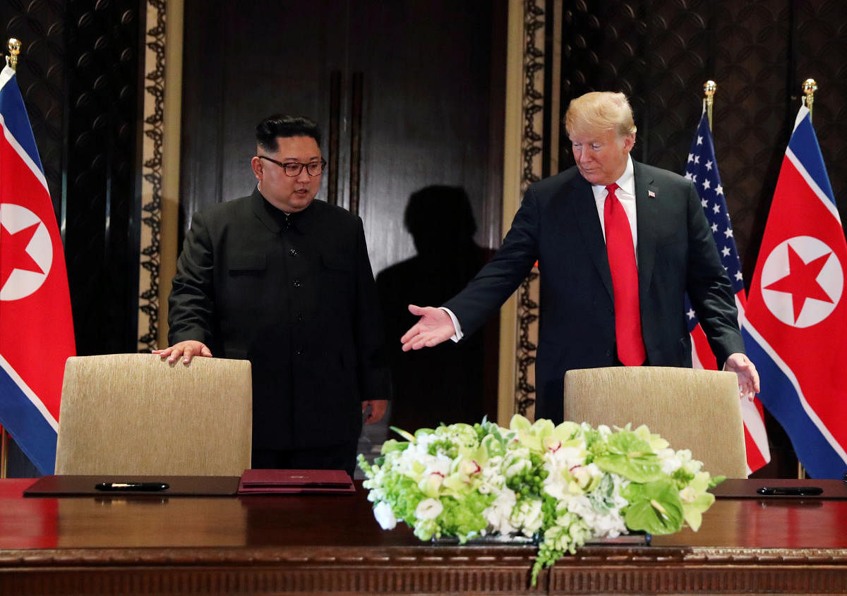 U.S. President Donald Trump and North Korea's leader Kim Jong Un (L) arrive to sign a document to acknowledge the progress of the talks and pledge to keep momentum going, after their summit at the Capella Hotel on Sentosa island in Singapore. Reuters file photo.