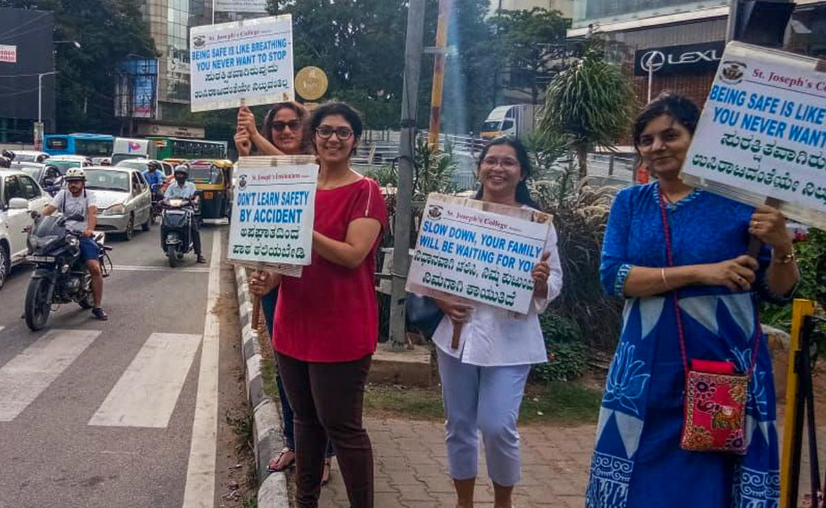Residents hold placards on road safety during their campaign at Richmond Circle on Sunday.