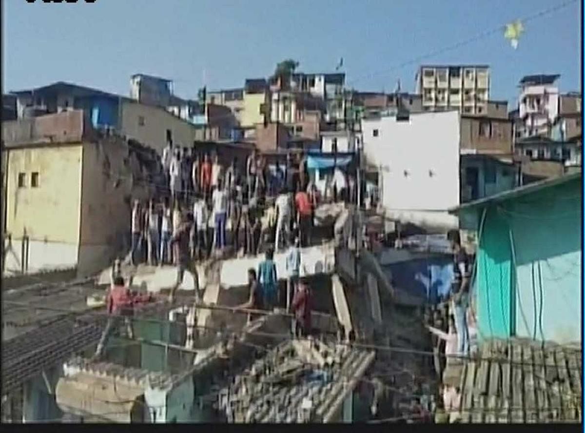 A 25-year-old woman was killed and eight others, including two children, were injured when a portion of a building collapsed on an adjoining chawl in Bhiwandi town near here, an official said on Wednesday. ANI file photo for representation