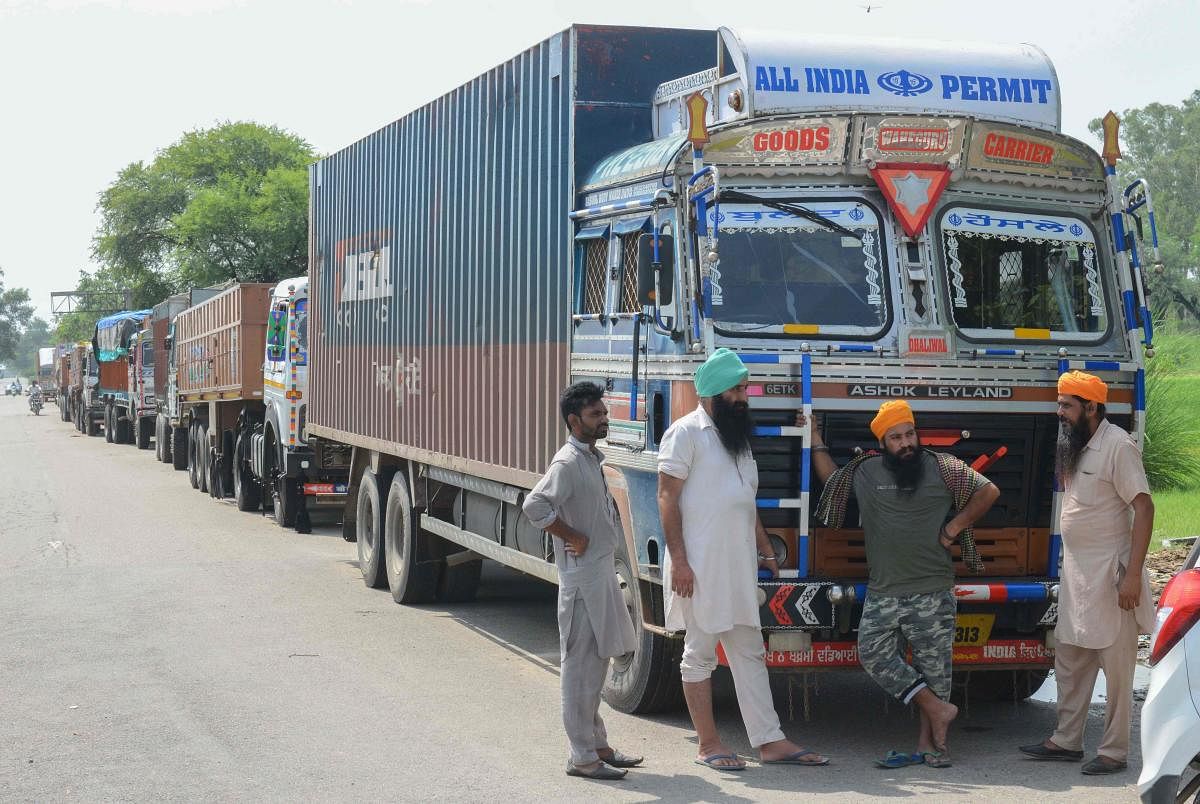 Truck drivers talk during a nationwide strike near the India-Pakistan border at Wagah post, near Amritsar, on Friday. (AFP)