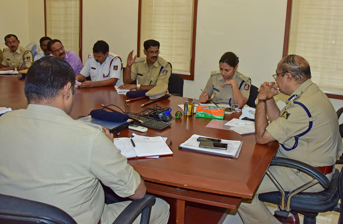 City Police Commissioner T R Suresh and other police officials during phone in programme in Mangaluru on Friday.