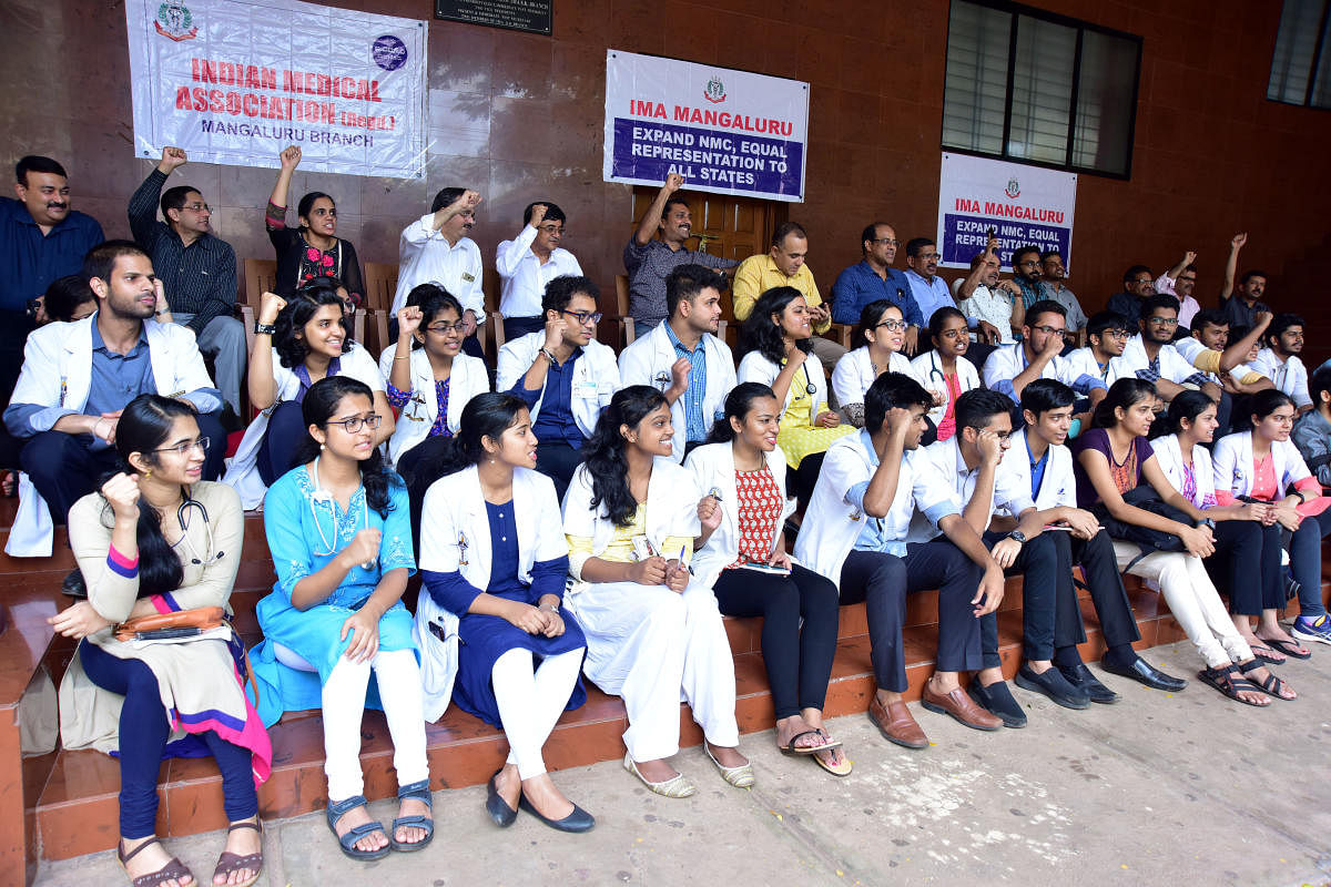 Doctors stage a protest under the aegis of IMA Mangaluru outside the IMA Bhavan in Mangaluru on Saturday.
