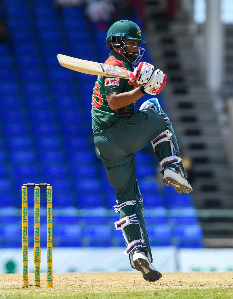 CLASSY: Tamim Iqbal of Bangladesh sends one to the fence en route his 103 against West Indies at Basseterre on Saturday. AFP