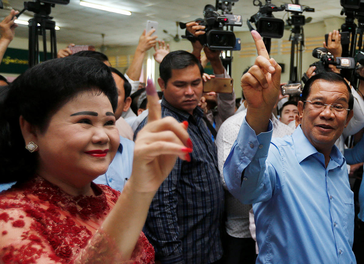 Cambodia's Prime Minister and President of the Cambodian People's Party (CPP) Hun Sen and his wife Bun Rany show their stained fingers at a polling station during a general election in Takhmao, Kandal province, Cambodia July 29, 2018. Reuters