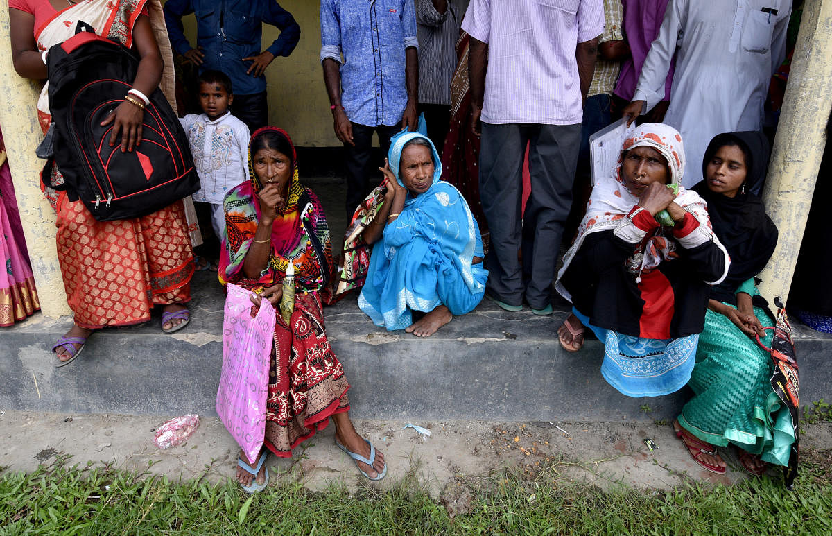 Villagers wait outside the National Register of Citizens (NRC) centre to get their documents verified by government officials, at Mayong Village in Morigaon district of Assam July 8, 2018. (REUTERS/Stringer)
