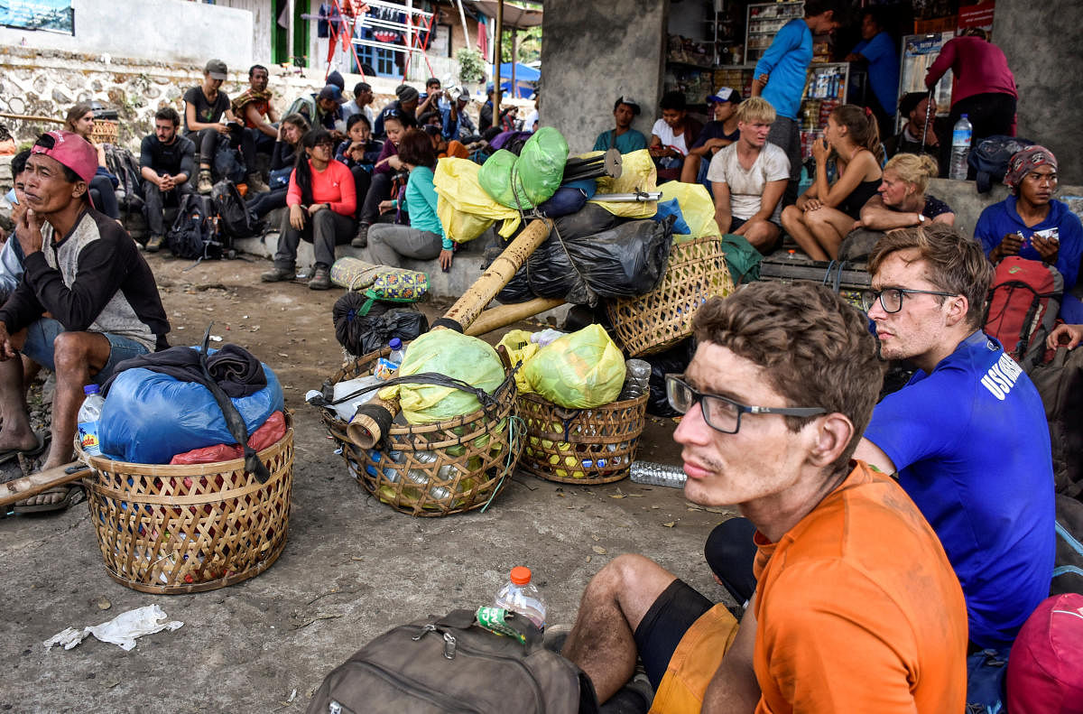 Indonesian and foreign climbers are seen after walking down from Rinjani Mountain at Sembalun village in Lombok Timur, Indonesia, July 29, 2018. (Antara Foto/Ahmad Subaidi/via REUTERS)