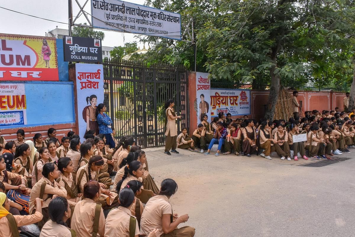 Students of Government Secondary School for Deaf &amp; Dumb stage a demonstration outside their school to highlight their problems, at JLN road in Jaipur on Monday. (PTI Photo)