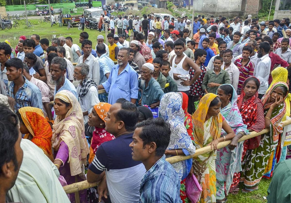 People wait to check their names on the final draft of the state's National Register of Citizens after it was released, at an NRC Seva Kendra in Tezpur on Monday, July 30, 2018. (PTI Photo) 