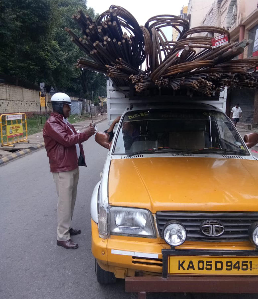A traffic policeman checks a goods vehicle for violations. 