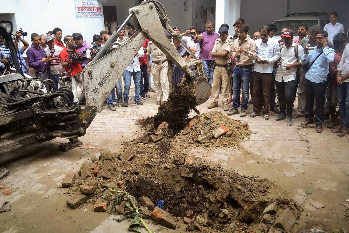 Police investigate the site where a rape victim was allegedly buried, at a government shelter home in Muzaffarpur, on Monday, July 23, 2018. A girl of the home has alleged that one of her fellow inmates was beaten to death and buried at the premises of the facility, and several were raped. (PTI Photo)