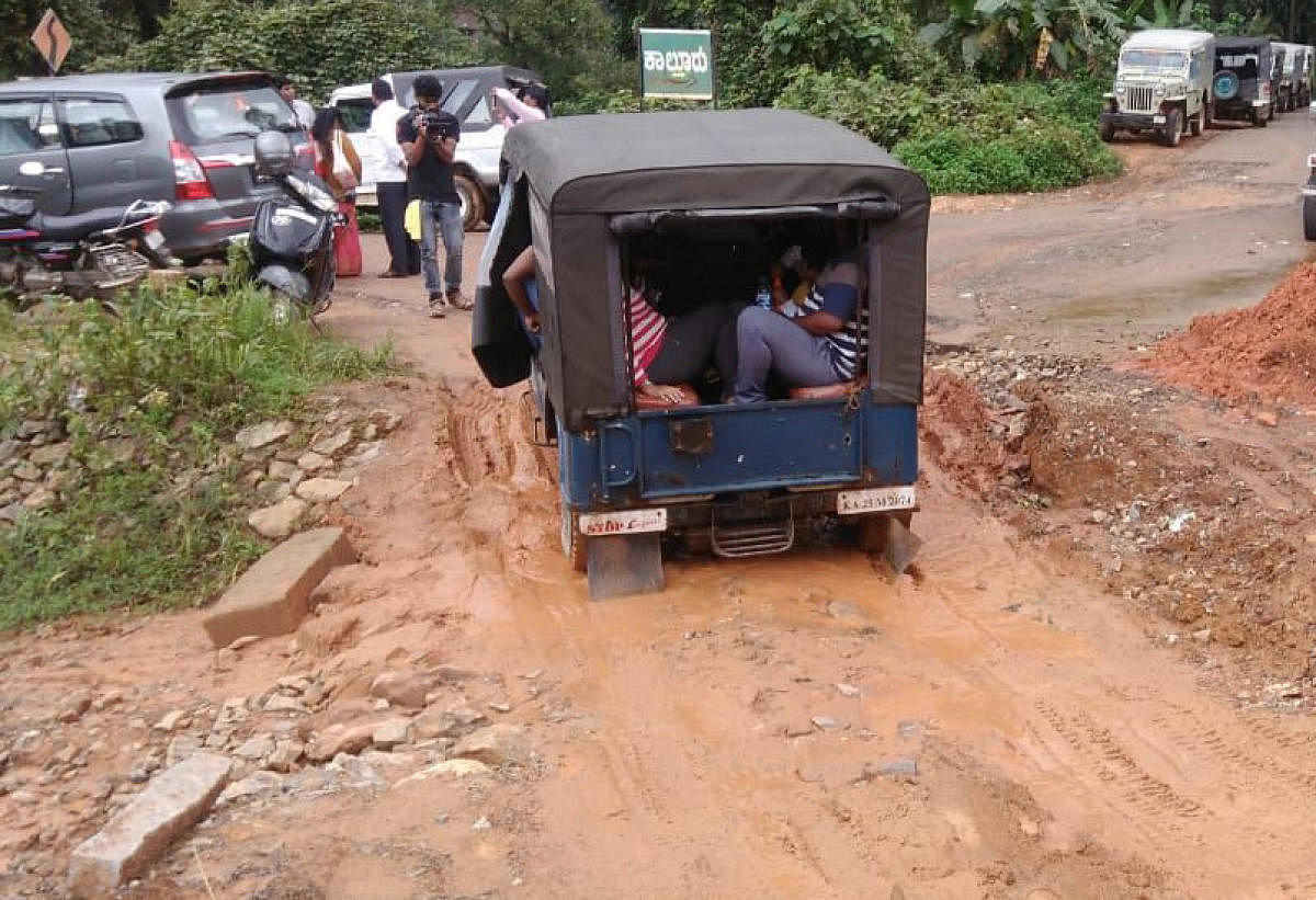 A jeep moves on a mud road, at Kaluru junction in Madikeri.
