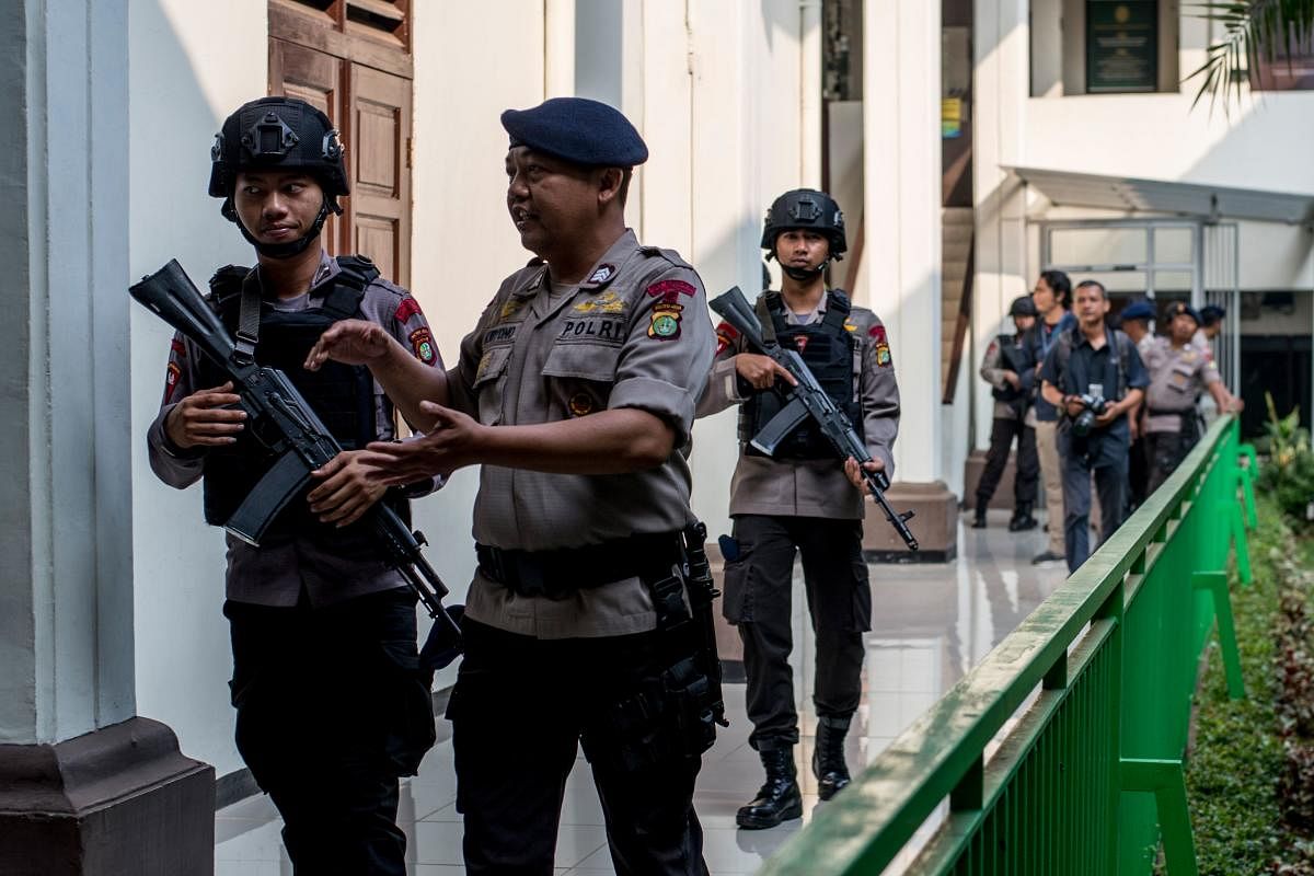 Armed police secure the South Jakarta court before a ruling against radical group Jemaah Ansharut Daulah (JAD) in Jakarta. AFP.
